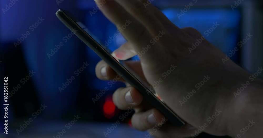 Hand Slides On Smartphone Display In Tech Background With Lights Closeup Hand Slides On Smartphone Display In Tech Background With Lights Closeup