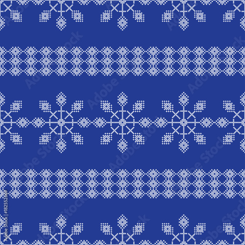 Seamless vector background cross stitch Norwegian snowflakes. Folk motifs. Winter pattern. Textile rapport.