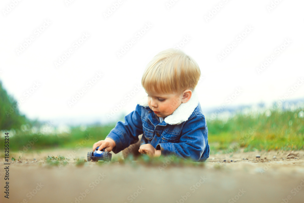 a boy plays in the sand