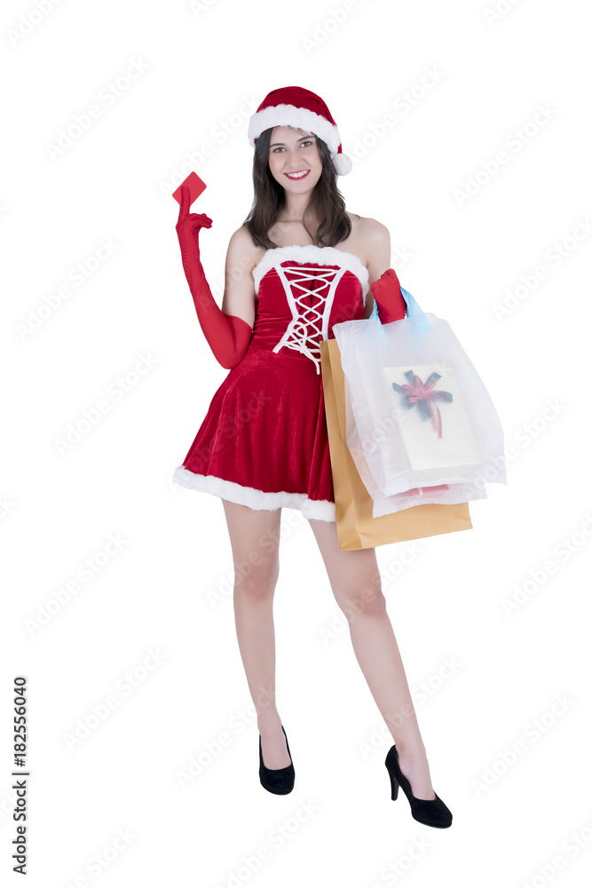Christmas concept : Beautiful smiling young Asian woman in Santa Claus costume holding credit card and shopping bags full of Christmas gifts isolated on white background Christmas concept : Beautiful smiling young Asian woman in Santa Claus costume holding credit card and shopping bags full of Christmas gifts isolated on white background