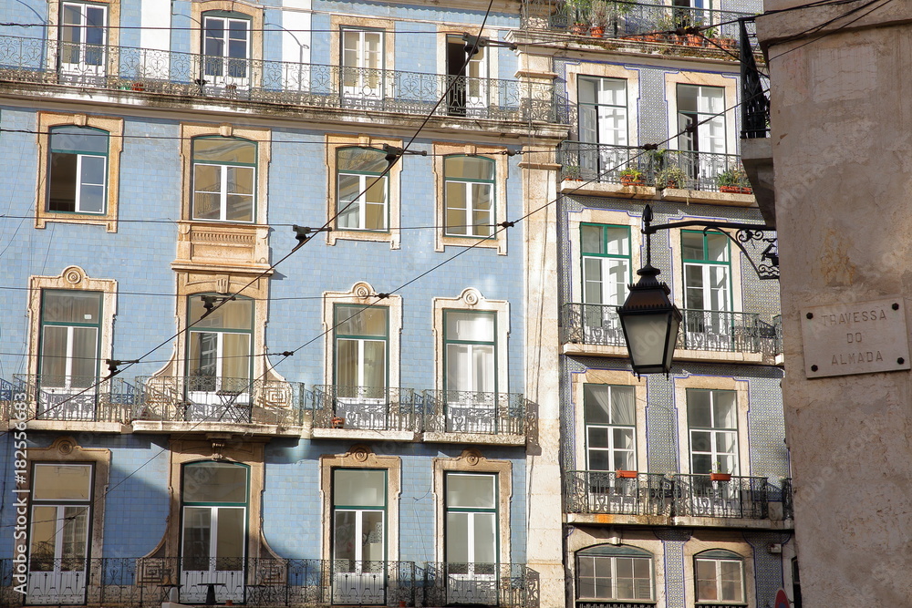 Colorful facades with wrought iron railing balconies in Alfama neighborhood, Lisbon, Portugal
