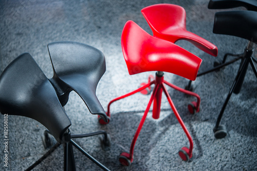 modern stylish red and black chair without backrest in the house