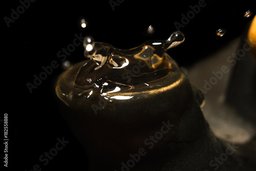 Drops from a spout of clay antique tea pot macro photo