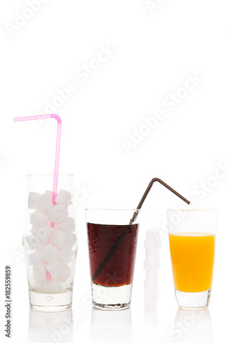 Cola, sugar cubes and orange juice in glass.