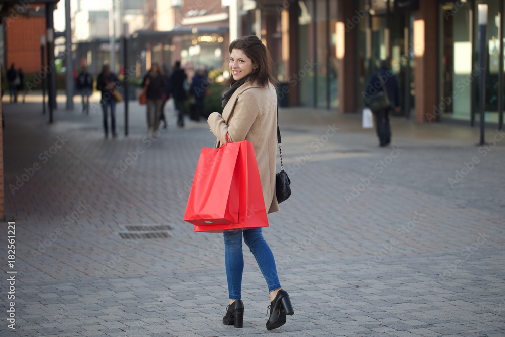 Fototapeta premium young woman doing shopping in outdoor shopping mall