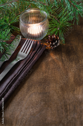 Rustic Christmas table setting with candle.