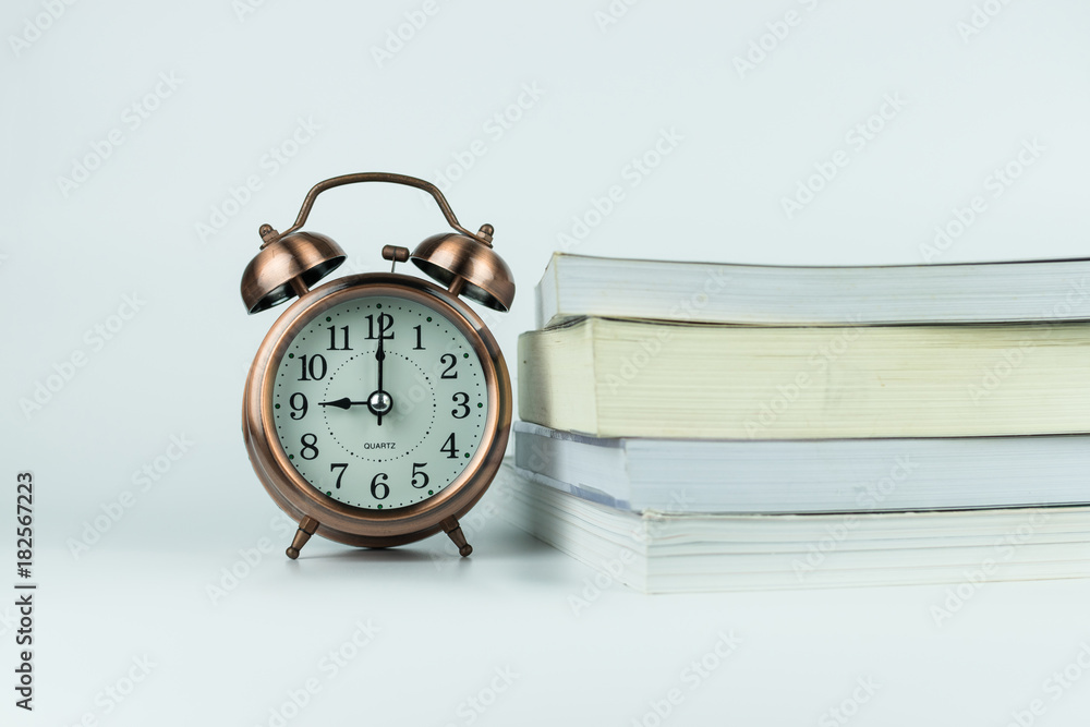Naklejka premium alarm clock and book