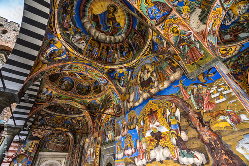 Vibrant religious painting on the ceiling of outer corridor of RIla Monastery, Bulgaria
