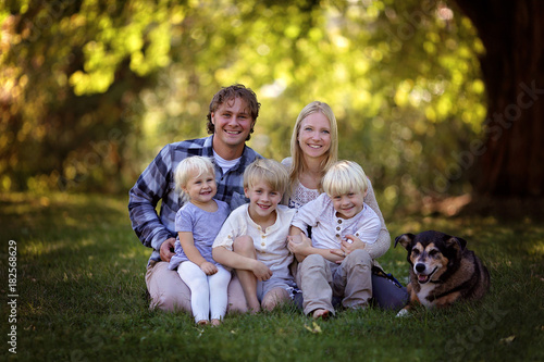 Portriat of Happy Family of Five Caucasian People and Their Pet Dog Outside