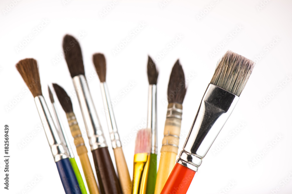 Paint brushes in a jar on whith background