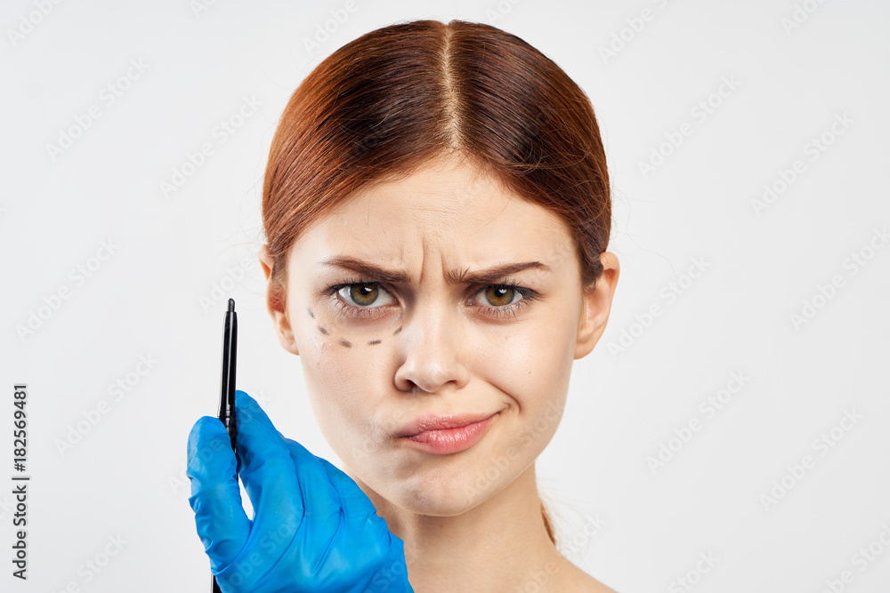 a girl in latex glove put a mark on her face a girl in latex glove put a mark on her face