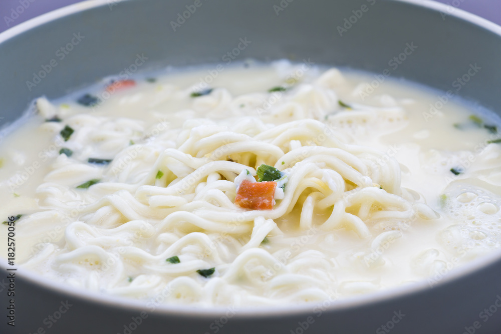 Cooking instant noodles, put egg and vegetables with hot soup in bowl.junk food or fast food concept. Cooking instant noodles, put egg and vegetables with hot soup in bowl.junk food or fast food concept.