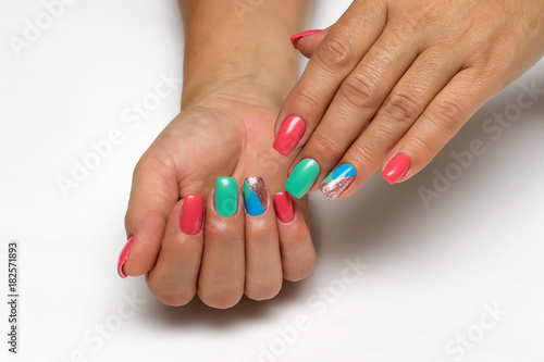 Bright blue, pink, gold, green, mint manicure with triangles on long square nails on a white background