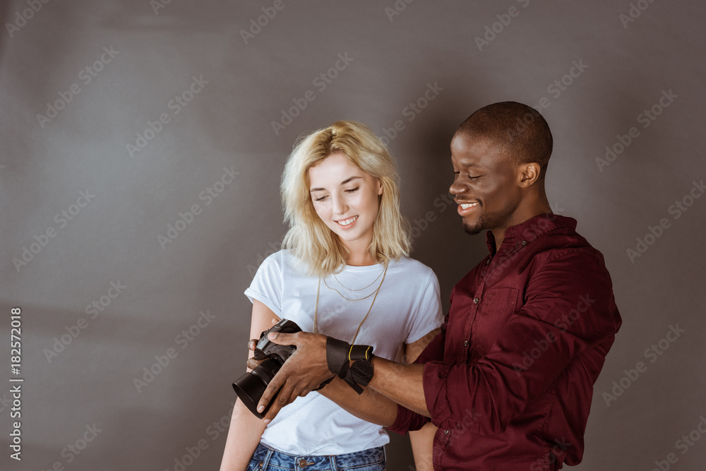 african american photographer and caucasian model choosing photos together during photoshoot in studio african american photographer and caucasian model choosing photos together during photoshoot in studio
