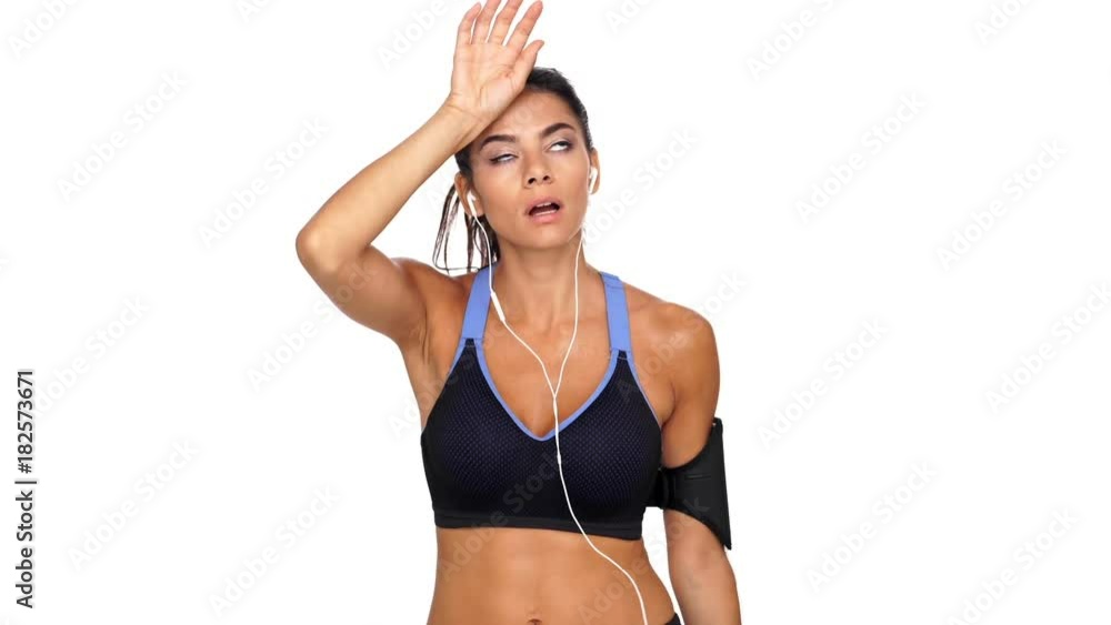 Tired brunette fitness woman having hot after run over white background Tired brunette fitness woman having hot after run over white background