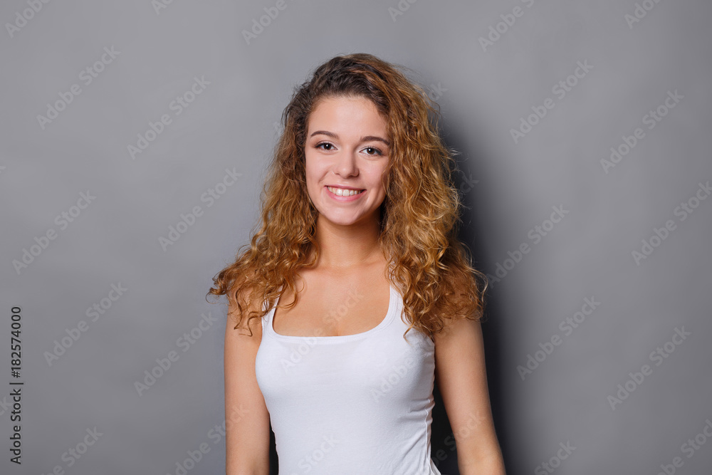 Smiling redhead girl posing at studio Smiling redhead girl posing at studio
