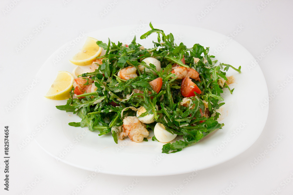 Salad with arugula and shrimp. Fresh dish with arugula, cherry tomatoes, shrimp on a plate. Salad with arugula and shrimp. Fresh dish with arugula, cherry tomatoes, shrimp on a plate.