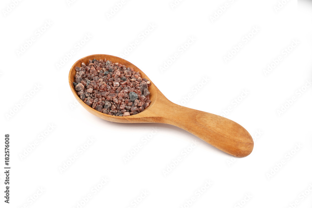 Close up wooden spoon of Indian brown salt Close up wooden spoon of Indian brown salt