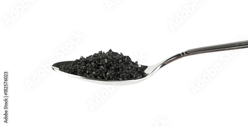 Close up metal spoon of black Hawaiian salt
