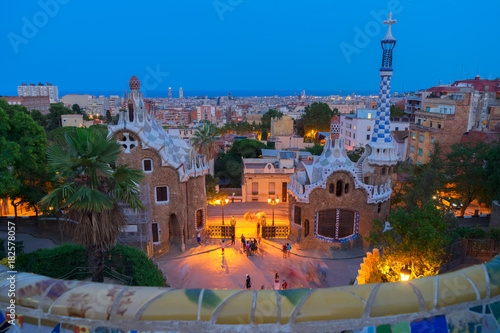 Gaudi bench and cityscape of Barcelona from park Guell illuminated at night, Spain