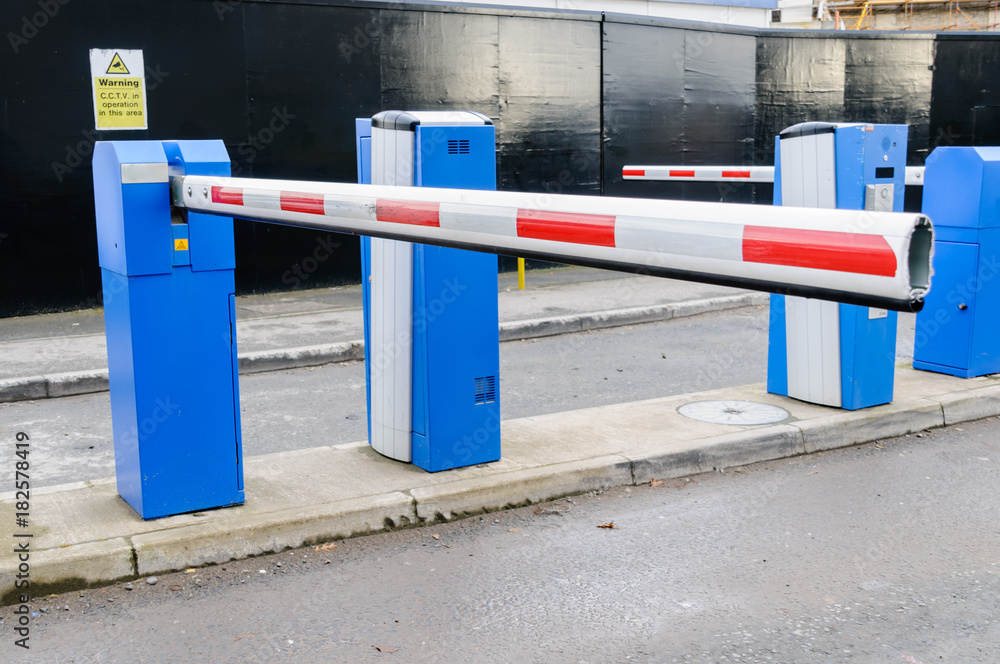 A traffic barrier at the entrance to a car park A traffic barrier at the entrance to a car park