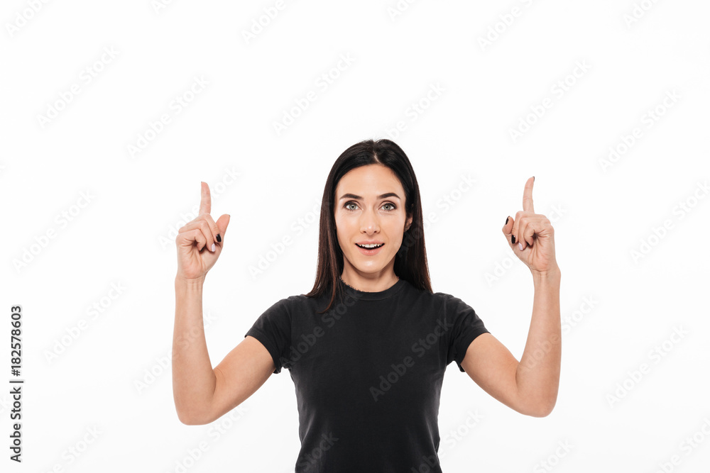 Portrait of a happy excited woman pointing two fingers up Portrait of a happy excited woman pointing two fingers up