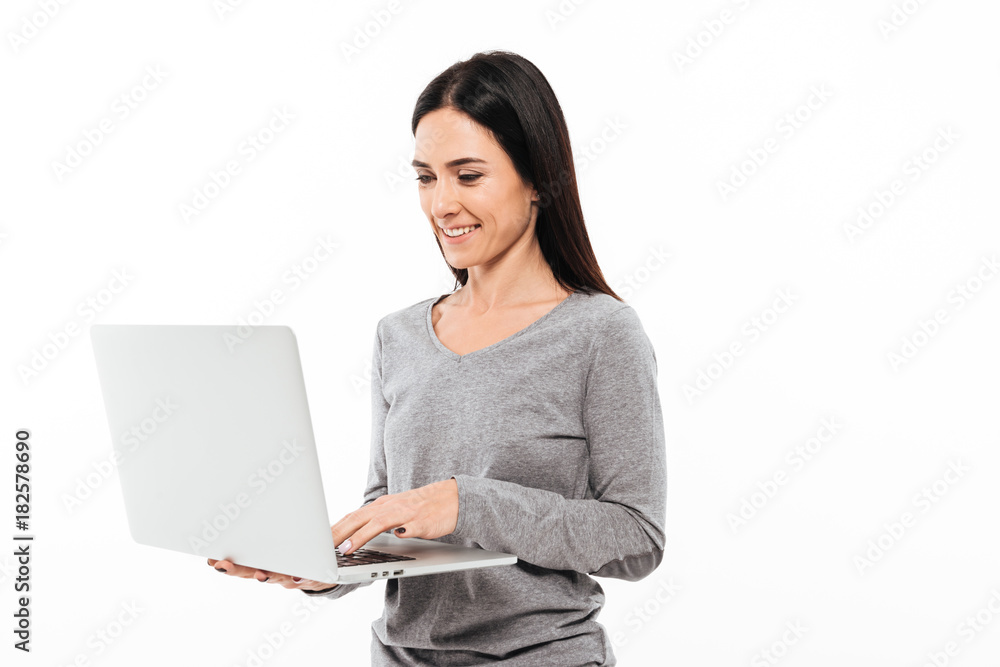 Young happy woman using laptop computer. Young happy woman using laptop computer.