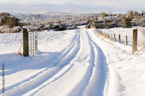 Snow covered rural lane with tyre tracks © Stephen