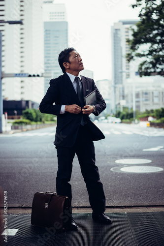 Senior business man moments on the streets of Tokyo