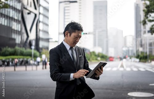 Senior business man moments on the streets of Tokyo