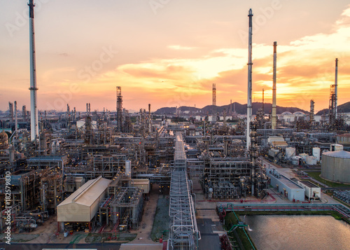 Aerial view Oil refinery.Industrial view at oil refinery plant form industry zone with sunrise and cloudy sky.Oil refinery and Petrochemical plant at dusk,Thailand. Oil refinery background sunset. © MAGNIFIER