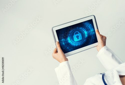Close of female doctor hands working with tablet pc computer