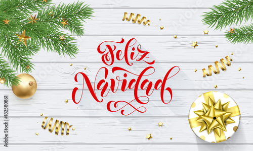 Feliz Navidad Spanish Merry Christmas holiday golden decoration on Xmas tree, calligraphy font for greeting card white wooden background. Vector Christmas or New Year golden shiny gift confetti design
