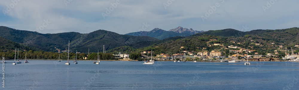 Few boats and ships in Elba bay near Italy Tuscany coastline