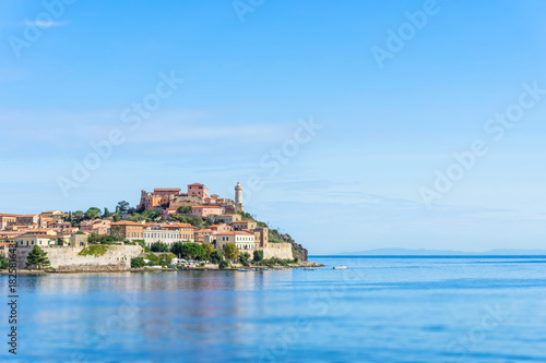 Bild auf Leinwand The lighthouse and other buildings in the town of Porto Ferraio