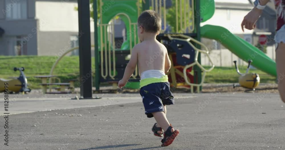 Mother and Toddler running at park in summer Mother and Toddler running at park in summer