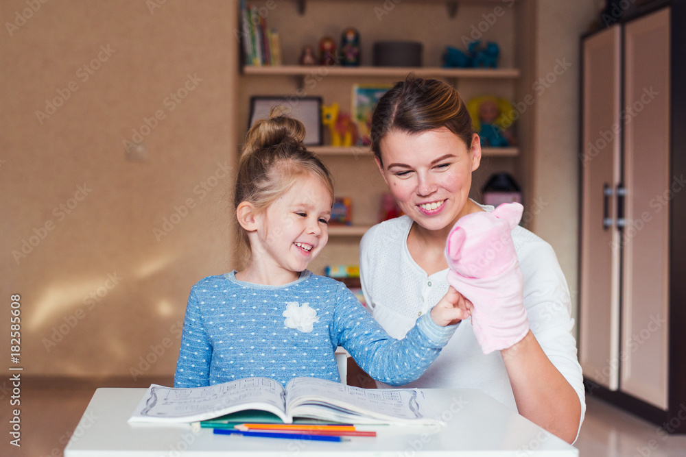 happy mother and daughter playing puppet pig and studying happy mother and daughter playing puppet pig and studying