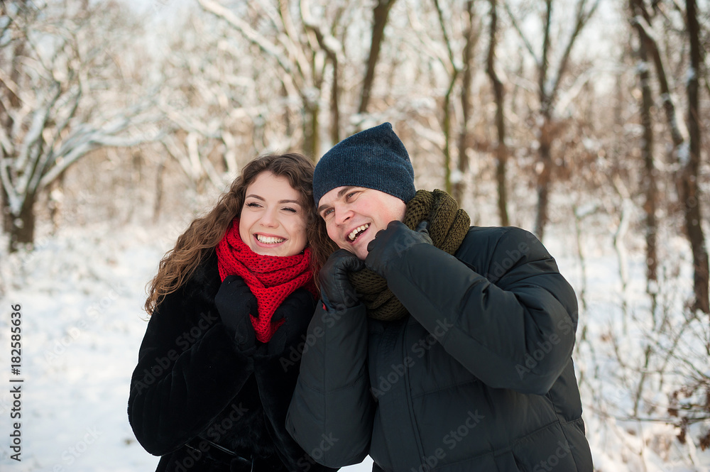Young couple walking in winter park Young couple walking in winter park