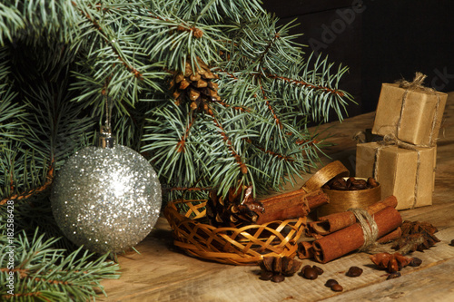 Christmas background decoration with grains of coffee, cinnamon, anise, lemon and spruce branches. 