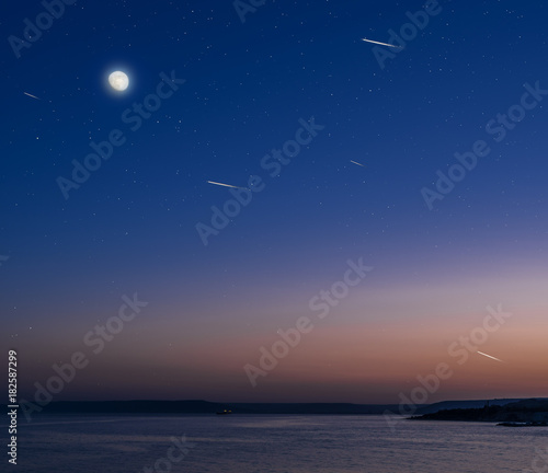 Moon and stars over the calm sea. © volff
