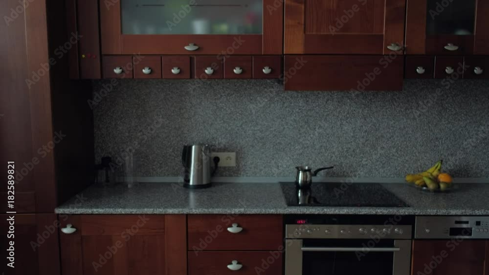 attractive young brunette with glasses long hair and loose clothing has fun and dancing in the kitchen, female dancing in the kitchen at Breakfast, a happy morning with coffee attractive young brunette with glasses long hair and loose clothing has fun and dancing in the kitchen, female dancing in the kitchen at Breakfast, a happy morning with coffee