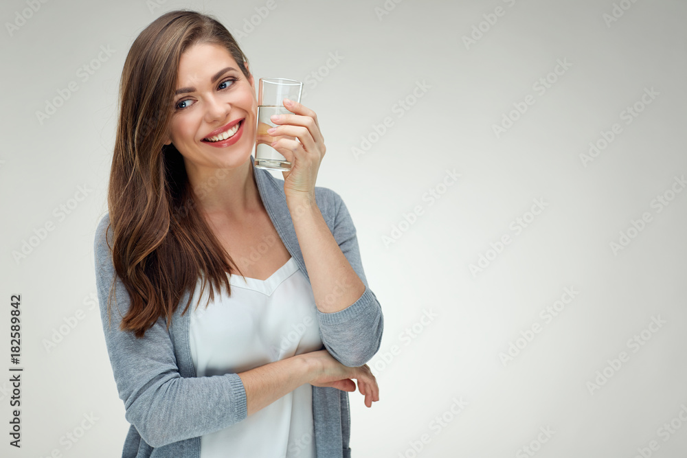 Young smiling woman holding water glass. Isolated studio portrait Young smiling woman holding water glass. Isolated studio portrait