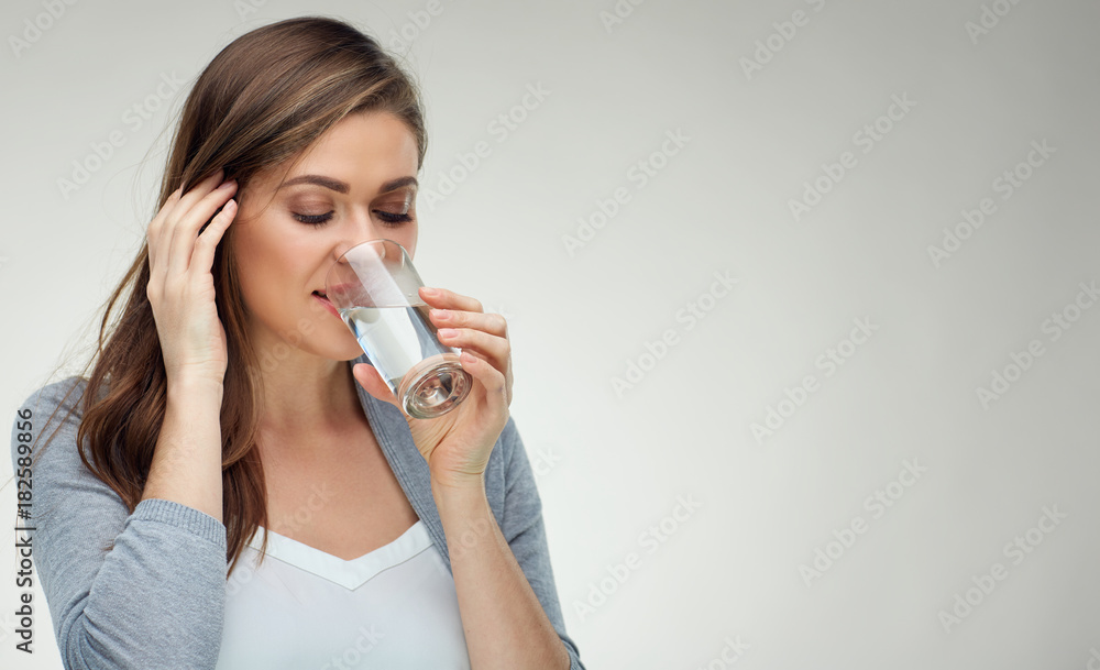 Smiling woman drinking water from glass. close up isolated face Smiling woman drinking water from glass. close up isolated face