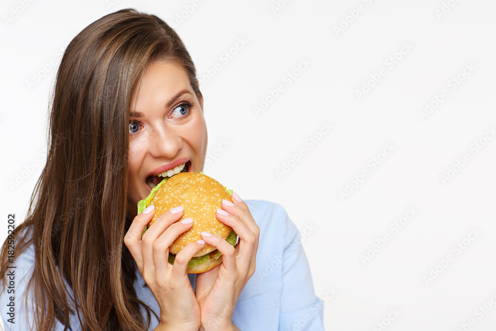 portrait of hungry woman eating burger. portrait of hungry woman eating burger.