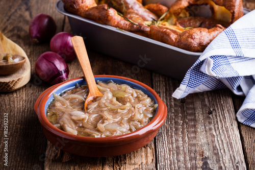 Onion gravy, sauce served with sausages photo