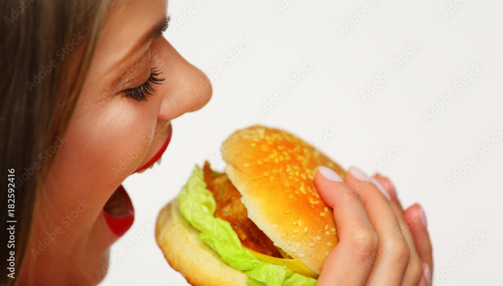 Close up portrait of woman face biting hamburger. Close up portrait of woman face biting hamburger.