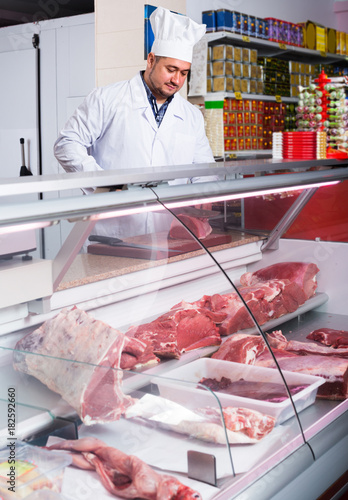 butcher cutting fresh lamb meat