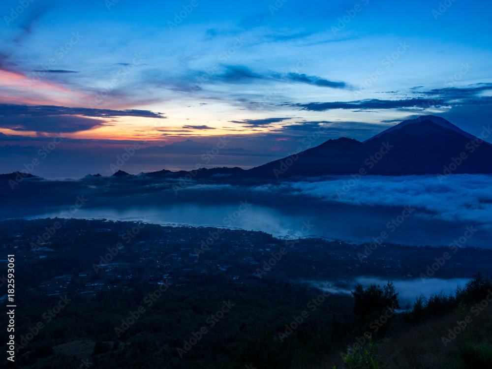 Batur volcano on the sunrise. Indonesia, autumn. It's an active volcano located at the center of two concentric calderas Batur volcano on the sunrise. Indonesia, autumn. It's an active volcano located at the center of two concentric calderas