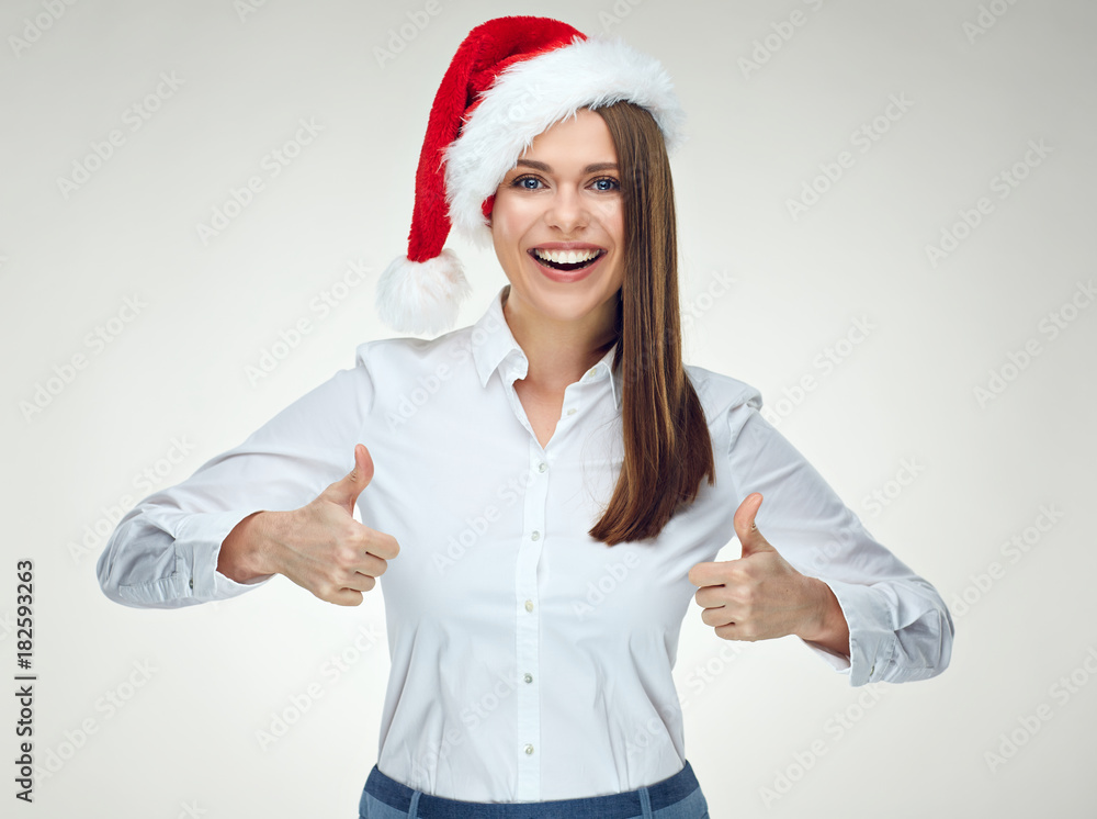 Smiling businesswoman wearing santa hat showing thumb up. Smiling businesswoman wearing santa hat showing thumb up.