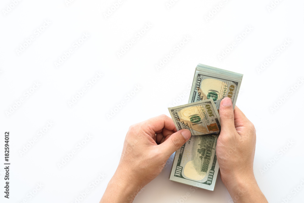 Human hand holding money of one hundred dollar bills isolated on white background. Human hand holding money of one hundred dollar bills isolated on white background.
